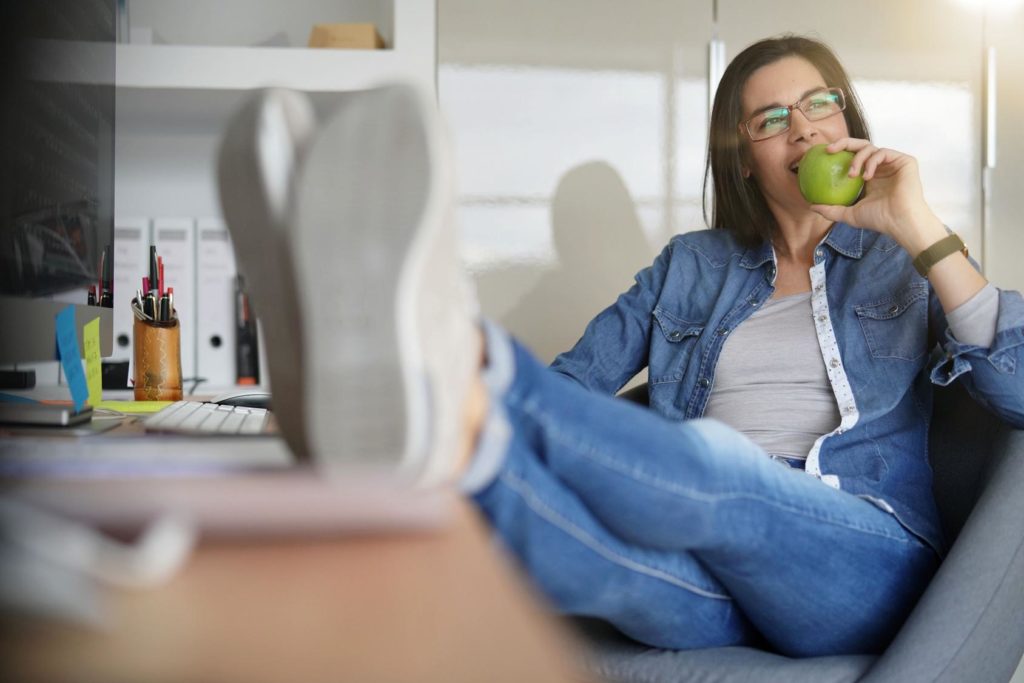 woman taking a break and eating an apple