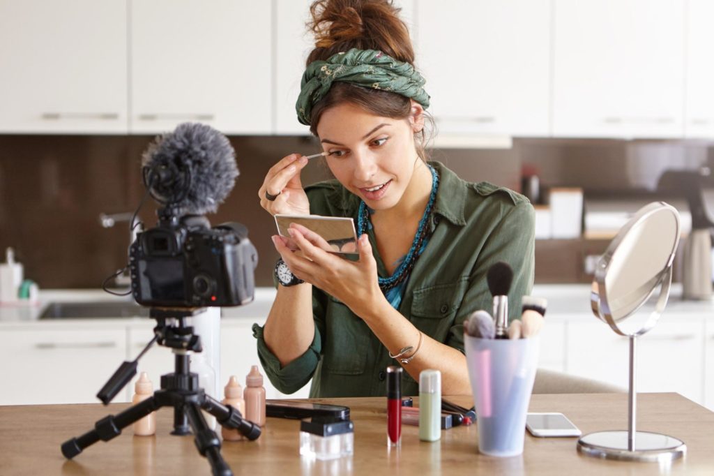 girl vlogger is shooting a make up tutorial