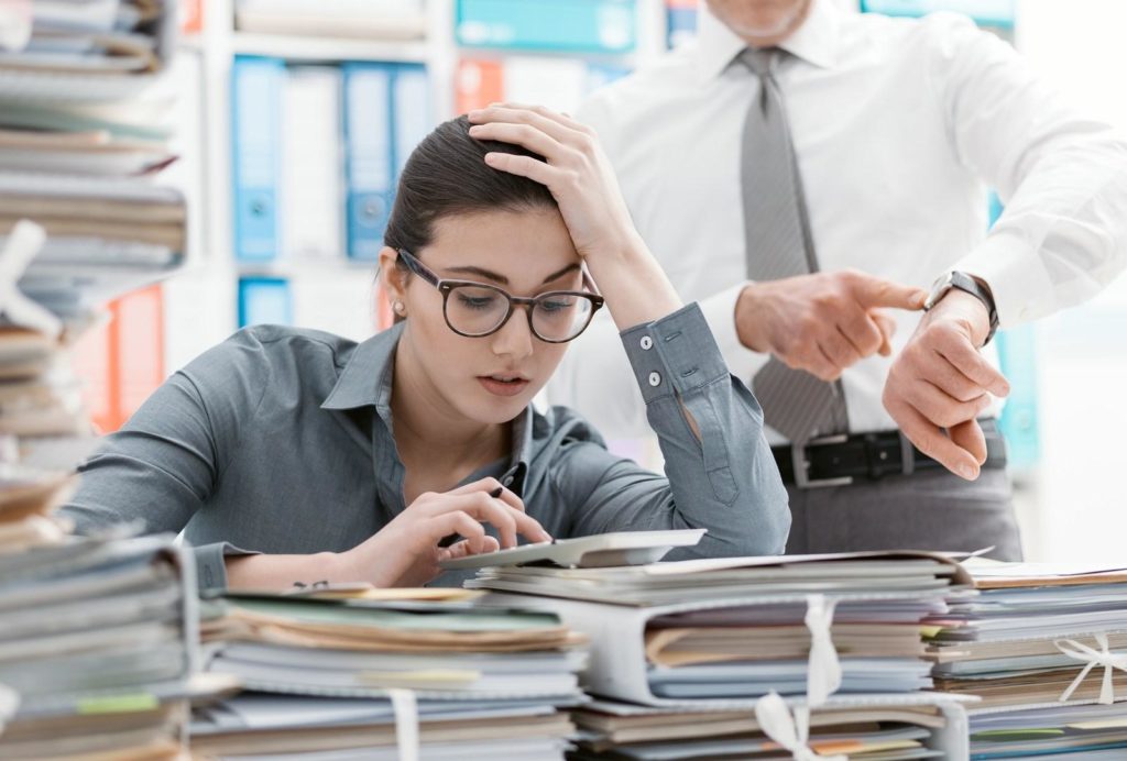 boss lecturing his employee about time management