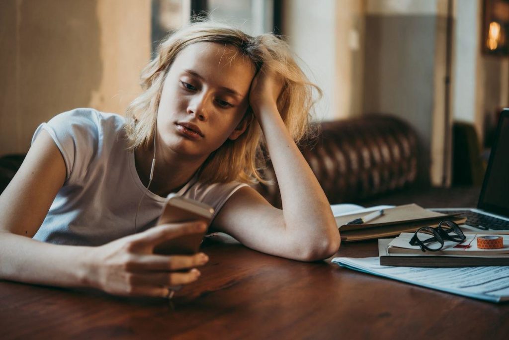 girl passes time by using her phone