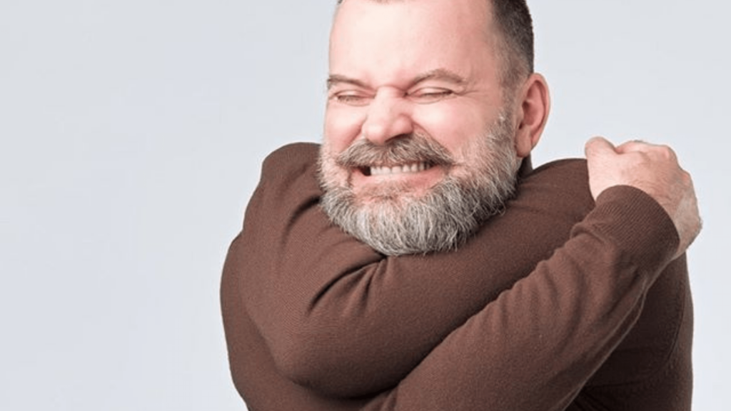 man hugging himself