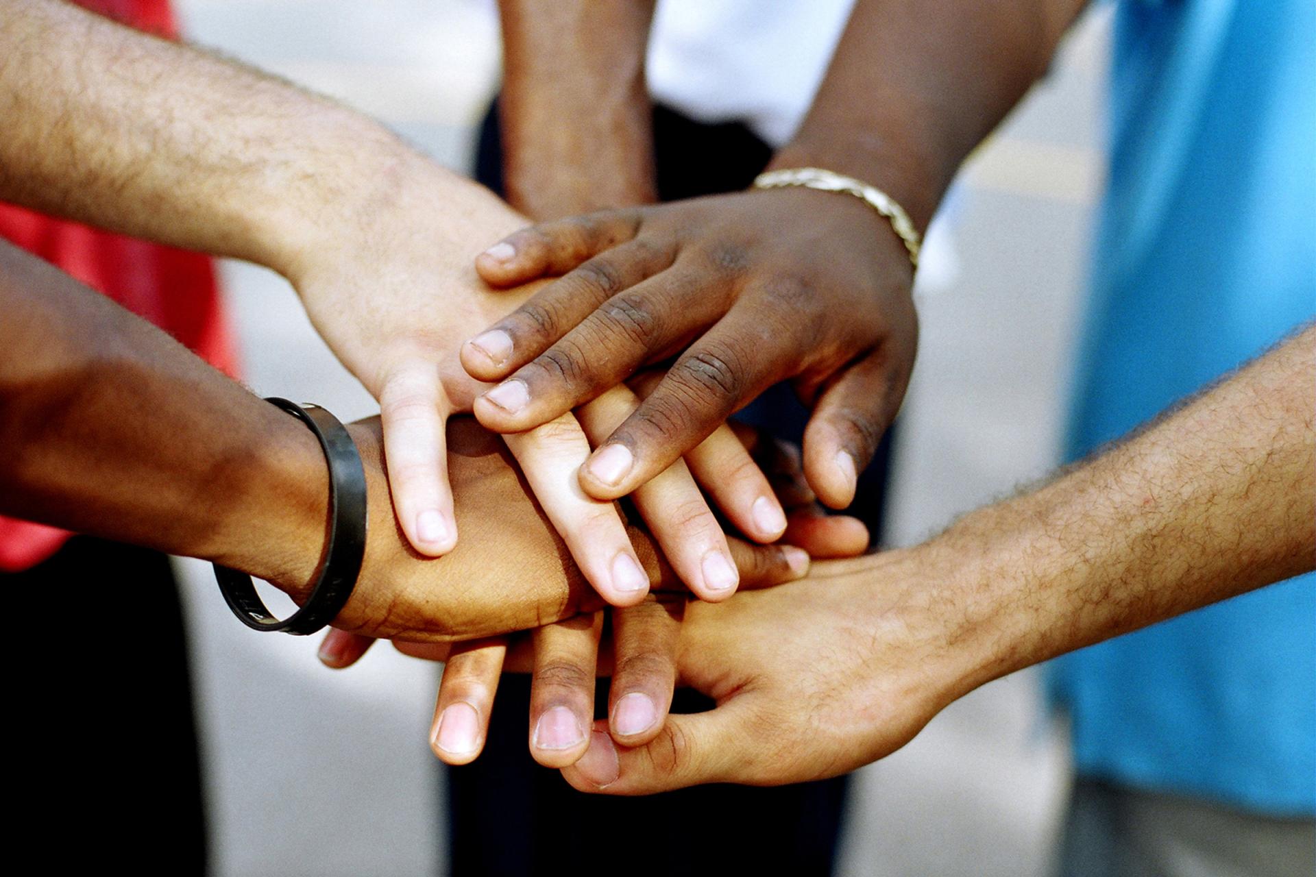 hands of people joining together creating a community
