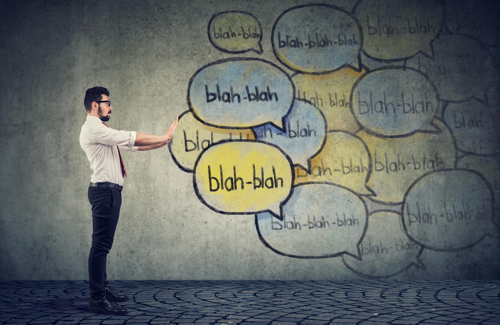 man holding speech bubbles to stop listening to everyone